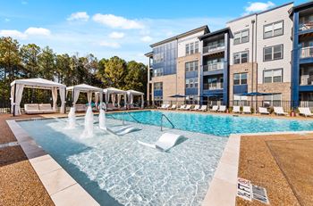 A pool with a fountain in the middle of it.